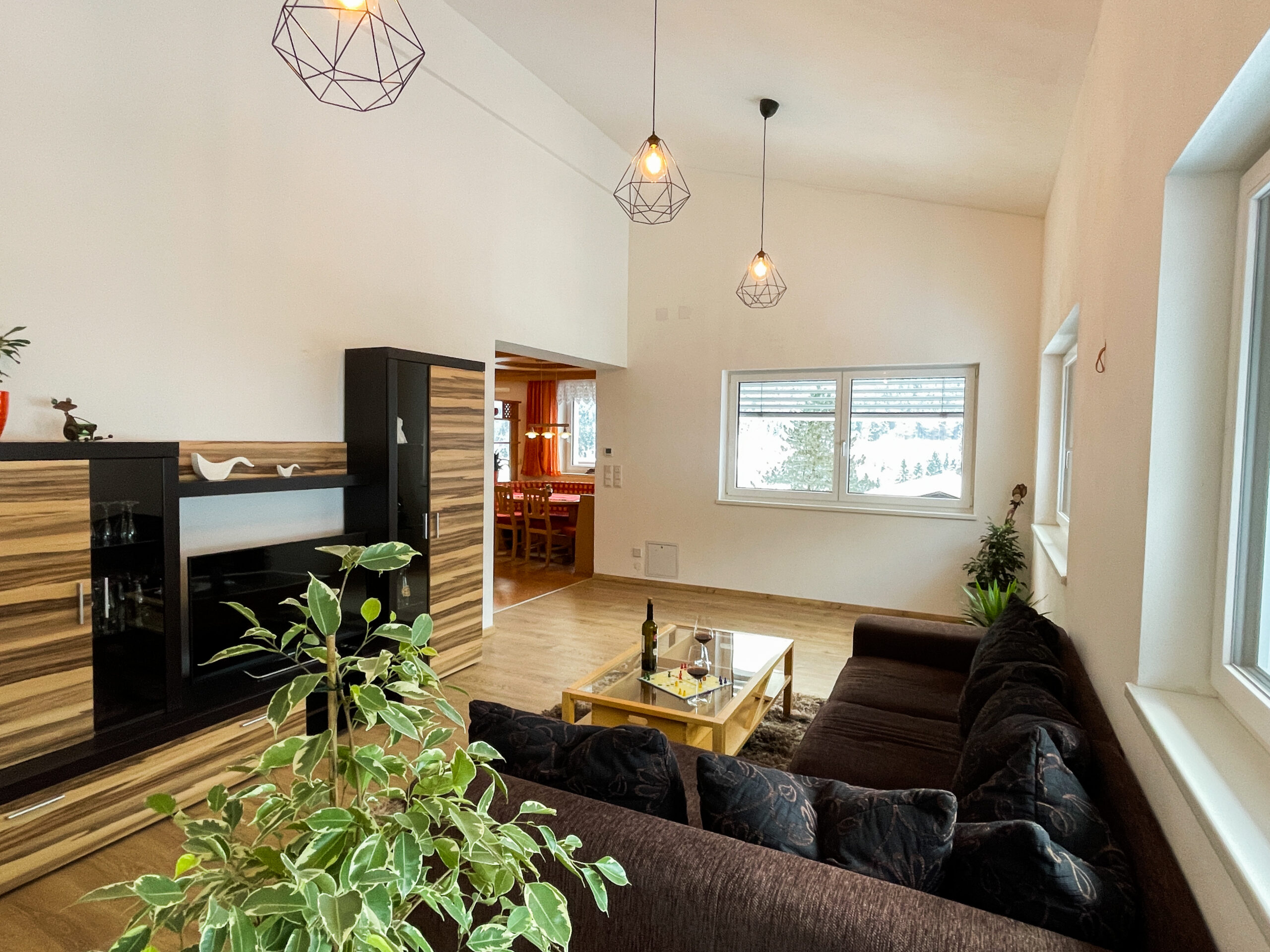 Helles Wohnzimmer mit Blick ins verschneite Lofer
